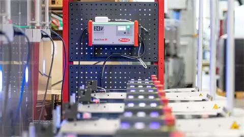 Lithium-ion traction batteries in front of a SelectION battery charger.